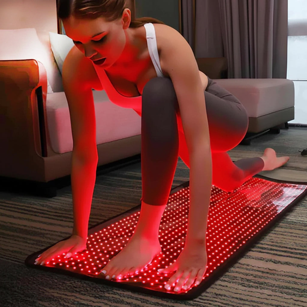 Woman doing yoga on red light therapy mat in modern living room